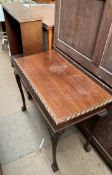 A mahogany side table with a rectangular top and gadrooned edge on shell capped cabriole legs and