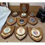 A collection of military shields and binoculars etc