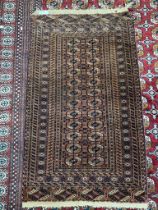 A red ground Turkoman rug with multiple guls and guard stripes,