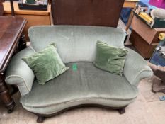 A green upholstered two seater settee,