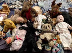 Assorted stuffed toys including teddy bears, cats, doll,