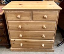 A pine chest with two short and three long drawers