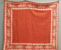 A hand quilted, machine pieced Welsh quilt in red and white,