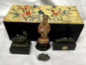 A carved oriental figure, together with a verdigris model of a lion (Bears a Sydney L Moss Ltd,