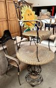 A wicker and metal table and two matching chairs