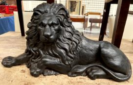 A cast iron door stop in the form of a recumbent lion
