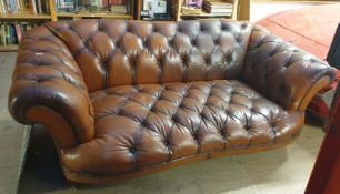 A brown leather three seater settee with button back upholstered seat,
