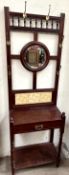 A Victorian mahogany hall stand with a central circular mirror,