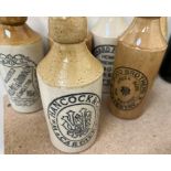 A collection of stoneware Ginger Beer bottles together with other bottles etc