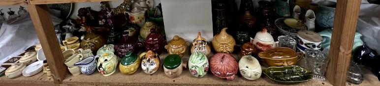 A collection of pottery caricature head preserve pots and covers together with assorted pottery