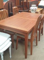 A mid 20th century teak extending dining table and four chairs