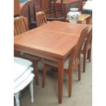 A mid 20th century teak extending dining table and four chairs