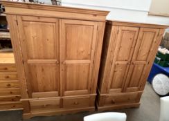 A large pine double door wardrobe with base drawer together with a matching smaller example