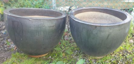 A pair of large brown glazed planters