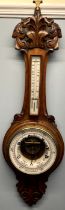An oak cased aneroid barometer with a mercury thermometer