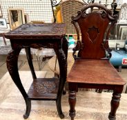 A Victorian mahogany hall chair with a shield shaped back and solid seat on turned legs together