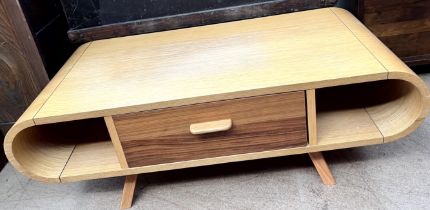 A 20th century oak coffee table with curved ends and a double sided pull through drawer on splayed