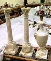 A pair of Corinthian column "Marble" candlestick style lamps and a "Marble" urn table lamp
