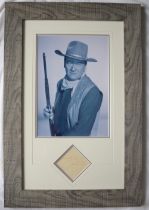 A Montage of a black and white photographs of John Wayne, signed to a separate sheet,