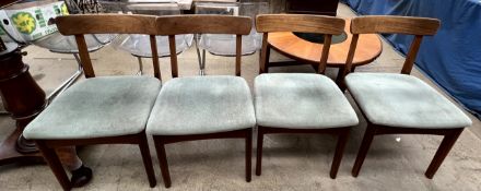 A set of four mid 20th century teak dining chairs with bar back an straight legs