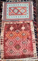 A rug with an orange and red ground decorated with multiple medallions,