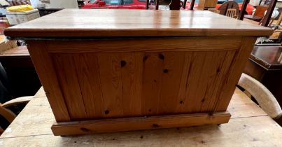 A pine coffer of rectangular form on a plinth