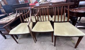 A set of six mid 20th century teak dining chairs includes two carvers