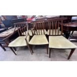 A set of six mid 20th century teak dining chairs includes two carvers