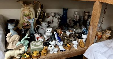 A Wade model of a Deer together with a collection of pottery cats,