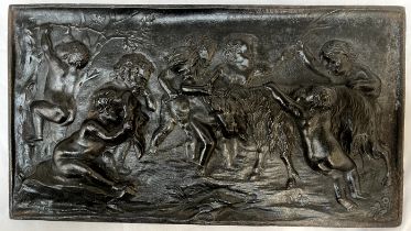 A cast iron plaque decorated with putti and a goat 36.