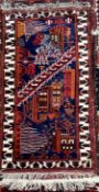 A rug with stylised buildings to a blue ground with geometric decorated guard stripes,