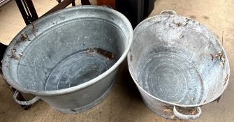 A galvanised twin handled tin bath together with another twin handled galvanised tin bath,