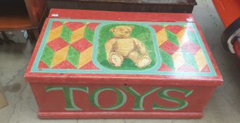 A pine coffer painted with a teddy bear and "TOYS"