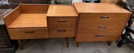 A mid 20th century teak chest with three drawers on tapering legs together with a matching