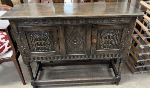 A 17th century style oak side cabinet,