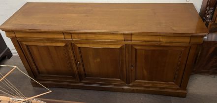 A 20th century sideboard with a rectangular top above three drawers and three cupboards on bracket