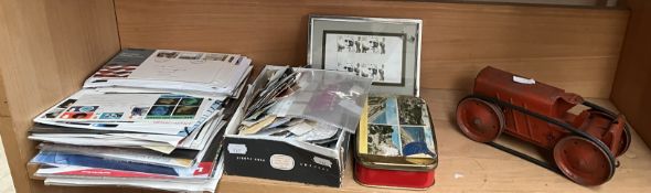 A tin plate wind up tractor together with a collection of loose stamps and first covers