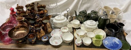 A collection of copper lustre jugs together with other jugs, teapots.