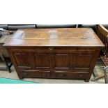 An 18th century panelled oak coffer, with a rectangular top above a four panelled front,