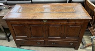 An 18th century panelled oak coffer, with a rectangular top above a four panelled front,