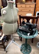 A dressmakers dummy together with a bird bath and a Singer sewing machine