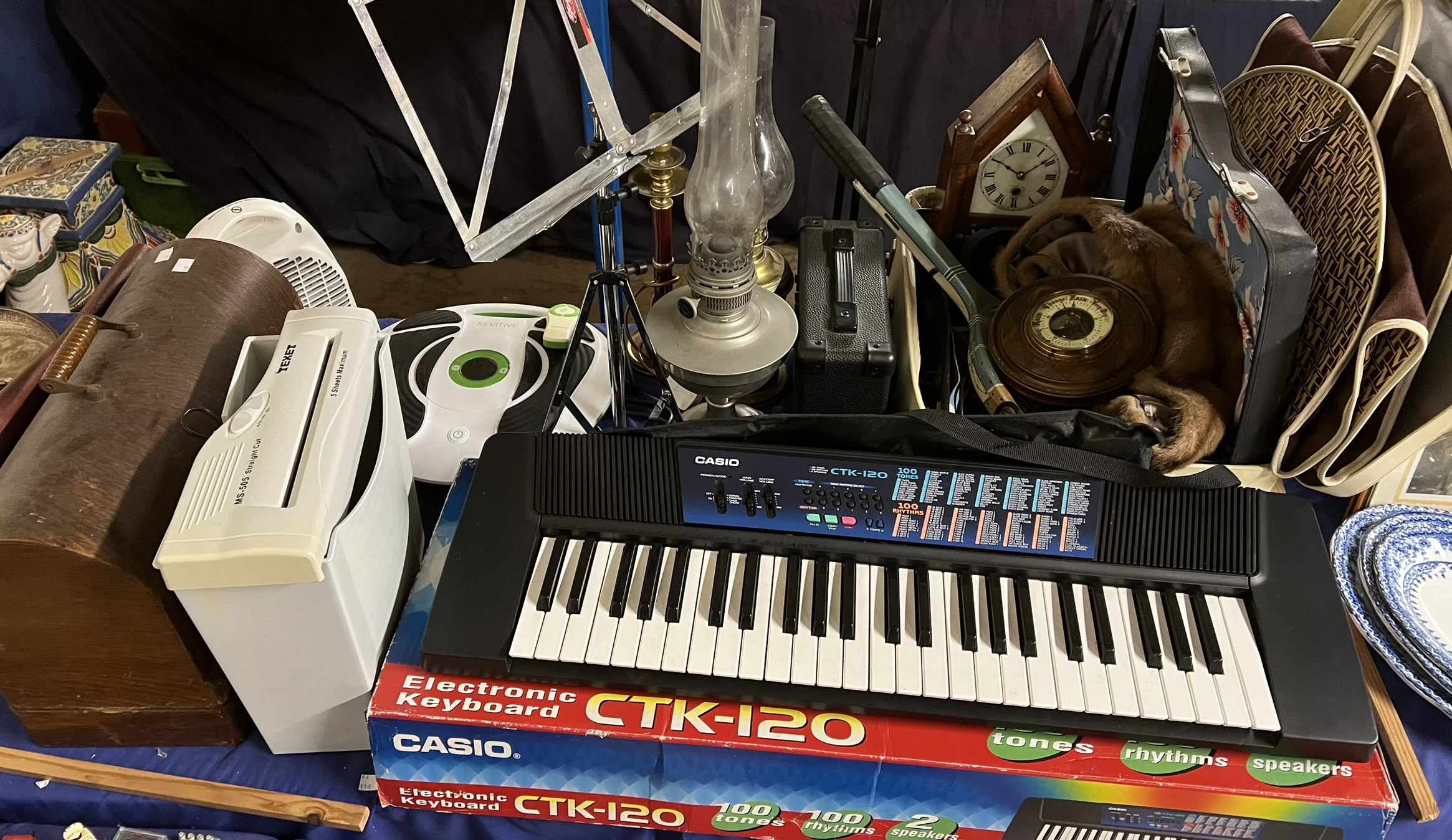 A Casio CTK-120 piano together with a Singer sewing machine, barometer, mantle clock, fur stole,