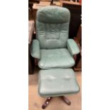 A green leather upholstered armchair and matching foot stool