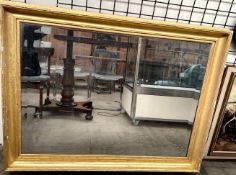 A large gilt framed wall mirror with a bevelled plate 109cm x 78cm