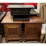 A pair of hardwood bedside cabinets with square tops above a slide and door on turned feet together