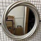 A large circular silvered framed wall mirror