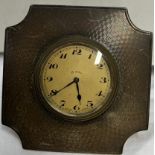 A silver desk clock with easel stand and 8 day movement