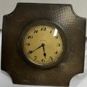 A silver desk clock with easel stand and 8 day movement