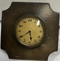 A silver desk clock with easel stand and 8 day movement