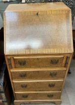 A 20th century walnut bureau with a sloping fall and four drawers